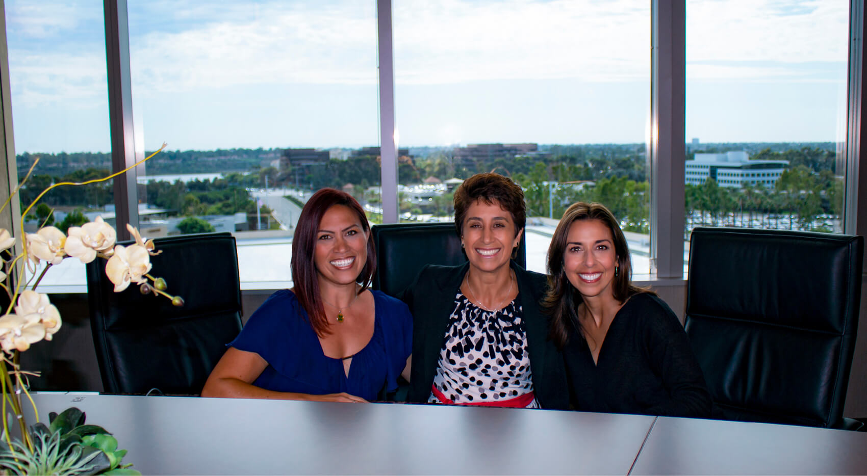 Impac executive assistants sitting around table